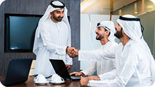 Group of corporate arab businessmen meeting in the office - Middle-eastern businesspeople wearing emirati kandora working in a meeting room, Dubai