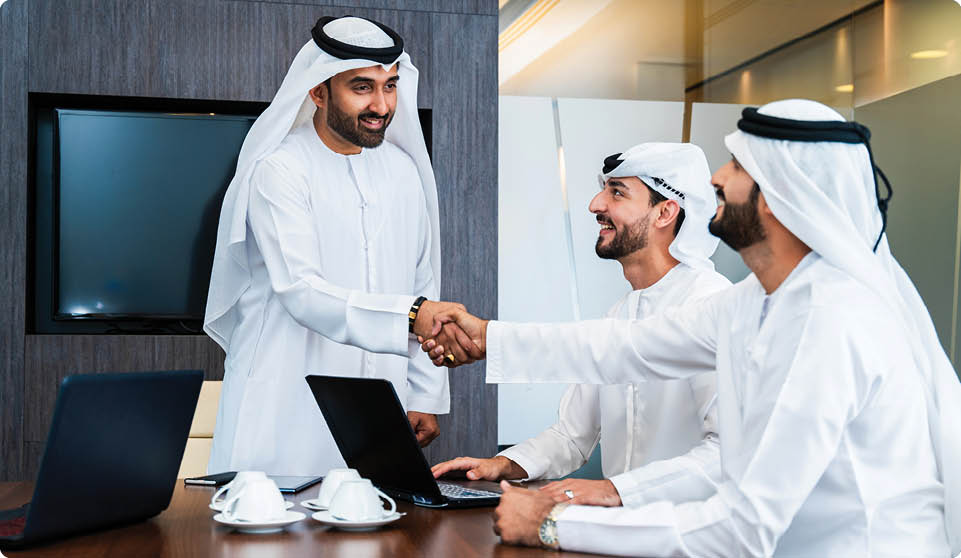 Group of corporate arab businessmen meeting in the office - Middle-eastern businesspeople wearing emirati kandora working in a meeting room, Dubai