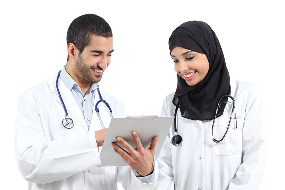 Arab saudi doctors reading together a medical history isolated on a white background               